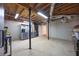 Spacious unfinished basement with exposed ceiling beams, concrete floor, and door, ideal for storage or future customization at 3004 High Vista Walk, Woodstock, GA 30189