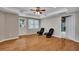 Finished basement with hardwood flooring, a tray ceiling with fan, and a door to the exterior at 3004 High Vista Walk, Woodstock, GA 30189