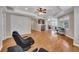 A spacious basement features hardwood floors, a kitchenette, recessed lights, and multiple windows at 3004 High Vista Walk, Woodstock, GA 30189