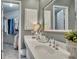 This bathroom features a white vanity, stylish fixtures, and a glimpse into the adjacent walk-in closet at 3004 High Vista Walk, Woodstock, GA 30189