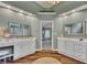 This bathroom has dual vanities, wood-look flooring, with views into the bathroom from the bedroom at 3004 High Vista Walk, Woodstock, GA 30189