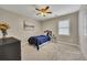 Cozy bedroom features neutral colors, a window with blinds, and a ceiling fan at 3004 High Vista Walk, Woodstock, GA 30189