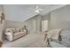 Spacious bedroom with a sitting area features neutral tones and a vaulted ceiling with ceiling fan at 3004 High Vista Walk, Woodstock, GA 30189