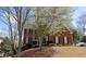 Beautiful two-story brick home featuring classic architectural details, well-maintained landscaping, and a welcoming entrance at 3004 High Vista Walk, Woodstock, GA 30189