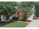 Spacious home featuring a two-car garage, brick and vinyl siding, and mature trees at 3004 High Vista Walk, Woodstock, GA 30189