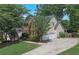 Beautiful two-story home with mature trees, a well-manicured lawn, and a two-car garage at 3004 High Vista Walk, Woodstock, GA 30189