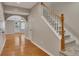 The home's foyer features hardwood flooring, a carpeted staircase, and an archway to the living space at 3004 High Vista Walk, Woodstock, GA 30189
