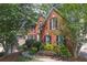 Attractive brick home with black shutters, mature trees, and manicured landscaping at 3004 High Vista Walk, Woodstock, GA 30189