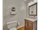 Charming half bathroom with dark vanity, granite counter, decorative mirror, and hardwood floors at 3004 High Vista Walk, Woodstock, GA 30189