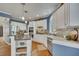 Bright kitchen with white cabinets, granite countertops, and stainless appliances at 3004 High Vista Walk, Woodstock, GA 30189