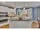 Beautiful kitchen featuring a center island, white cabinetry, and natural lighting at 3004 High Vista Walk, Woodstock, GA 30189