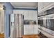 This kitchen features white cabinets, stainless steel appliances and a blue accent wall at 3004 High Vista Walk, Woodstock, GA 30189
