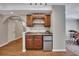 A kitchenette features wood cabinets, a stainless-steel mini fridge, and views into another room at 3004 High Vista Walk, Woodstock, GA 30189