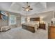 This spacious main bedroom features a trey ceiling, plush carpet, and a large bed, creating a luxurious retreat at 3004 High Vista Walk, Woodstock, GA 30189
