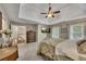 This main bedroom features soft carpet, a trey ceiling, a wall-mounted TV, and abundant natural light at 3004 High Vista Walk, Woodstock, GA 30189
