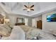 This expansive main bedroom offers soft carpet, a trey ceiling, a wall-mounted TV, and calming neutral colors at 3004 High Vista Walk, Woodstock, GA 30189