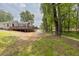 Expansive backyard features a home with a large wooden deck, and fenced perimeter at 7619 Campground Rd, Cumming, GA 30040