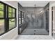 Bathroom featuring modern shower with sleek glass door and stylish tile at 7619 Campground Rd, Cumming, GA 30040