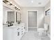 Bathroom featuring double vanity, marble floors, and modern lighting at 7619 Campground Rd, Cumming, GA 30040