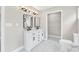 Bright bathroom featuring double sink vanity with marble countertop and modern fixtures at 7619 Campground Rd, Cumming, GA 30040