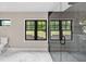 Modern bathroom featuring a glass shower, gray tile, and marble flooring at 7619 Campground Rd, Cumming, GA 30040