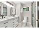 Modern bathroom featuring a double vanity with marble countertop and glass-enclosed shower at 7619 Campground Rd, Cumming, GA 30040
