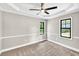 Neutral bedroom with new carpet, ceiling fan, white trim, and multiple windows at 7619 Campground Rd, Cumming, GA 30040