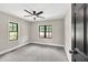 Bright bedroom featuring carpeting, neutral walls, and black window trim at 7619 Campground Rd, Cumming, GA 30040
