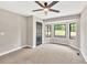 Bedroom featuring new carpet, ceiling fan, white trim, and bay windows at 7619 Campground Rd, Cumming, GA 30040