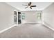 Spacious primary bedroom featuring carpet and modern ceiling fan at 7619 Campground Rd, Cumming, GA 30040