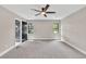 Large primary bedroom with carpeting and view of bathroom at 7619 Campground Rd, Cumming, GA 30040