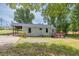 Charming home with a covered porch, green exterior, and a spacious yard at 7619 Campground Rd, Cumming, GA 30040