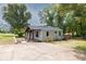 Home featuring an inviting facade with a covered porch and a driveway at 7619 Campground Rd, Cumming, GA 30040