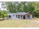 Home featuring a welcoming covered porch, charming architecture, and well-kept yard at 7619 Campground Rd, Cumming, GA 30040