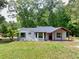 Inviting single-story home featuring a covered front porch and complemented by a well-maintained lawn at 7619 Campground Rd, Cumming, GA 30040