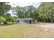 Charming home featuring covered porch, and mature trees at 7619 Campground Rd, Cumming, GA 30040