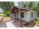 Inviting home exterior featuring a cozy covered front porch and well-maintained landscaping at 7619 Campground Rd, Cumming, GA 30040