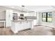 Updated kitchen with white cabinets, granite counters, stainless steel appliances, and a kitchen island with pendant lighting at 7619 Campground Rd, Cumming, GA 30040