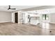Open-concept kitchen with white cabinetry, granite countertops, stainless steel appliances, and center island at 7619 Campground Rd, Cumming, GA 30040
