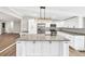 Modern kitchen with granite countertops, stainless steel appliances, and a large island at 7619 Campground Rd, Cumming, GA 30040