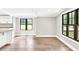 Bright, open living area with hardwood floors, white trim, and large windows at 7619 Campground Rd, Cumming, GA 30040