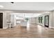 Open-concept living area with hardwood floors seamlessly flowing into a modern kitchen at 7619 Campground Rd, Cumming, GA 30040