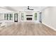 Spacious living area featuring wood-look floors, a modern fireplace, and views into the open-concept kitchen at 7619 Campground Rd, Cumming, GA 30040