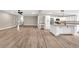 Open-concept home featuring new wood flooring, modern kitchen and recessed lighting at 7619 Campground Rd, Cumming, GA 30040