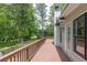 Expansive wooden deck provides a tranquil outdoor space surrounded by lush greenery at 7619 Campground Rd, Cumming, GA 30040
