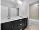 Bathroom with dual sinks, dark cabinets, and a separate shower and tub at 891 Proctor Oaks Nw St, Atlanta, GA 30318