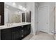 Bathroom featuring a dual sink vanity with dark cabinets, mirror, and modern lighting at 891 Proctor Oaks Nw St, Atlanta, GA 30318