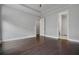 Large bedroom featuring hardwood floors, a tray ceiling, and neutral gray walls at 891 Proctor Oaks Nw St, Atlanta, GA 30318