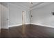Bedroom showcasing hardwood floors, a tray ceiling, and a walk-in closet at 891 Proctor Oaks Nw St, Atlanta, GA 30318