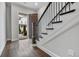 Entryway with dark hardwood floors, staircase, and an open door showcasing the exterior at 891 Proctor Oaks Nw St, Atlanta, GA 30318